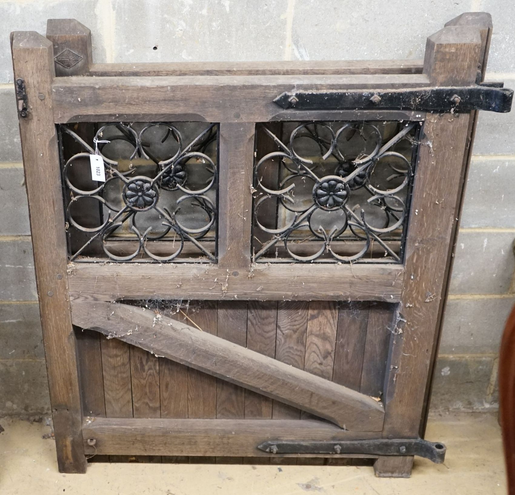 A pair of oak and wrought iron gates, each width 107cm, height 133cm